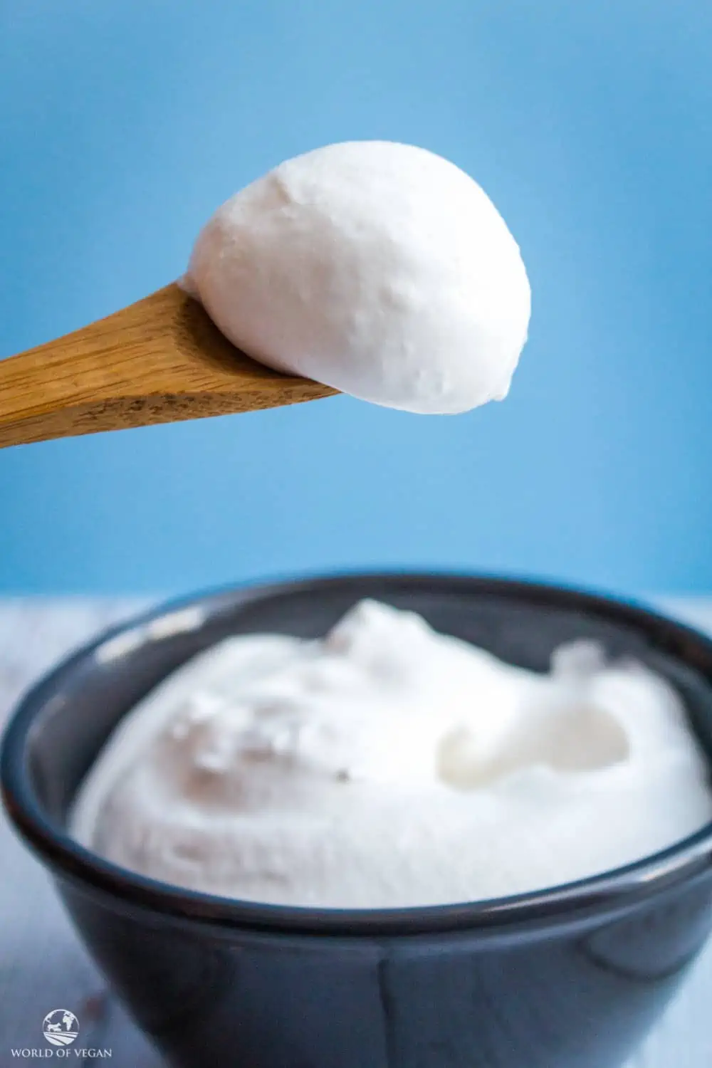 Coconut Whipped Cream on a wooden spoon.