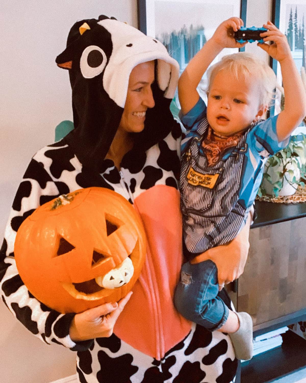 A mom in a vegan Halloween cow costume with her baby.