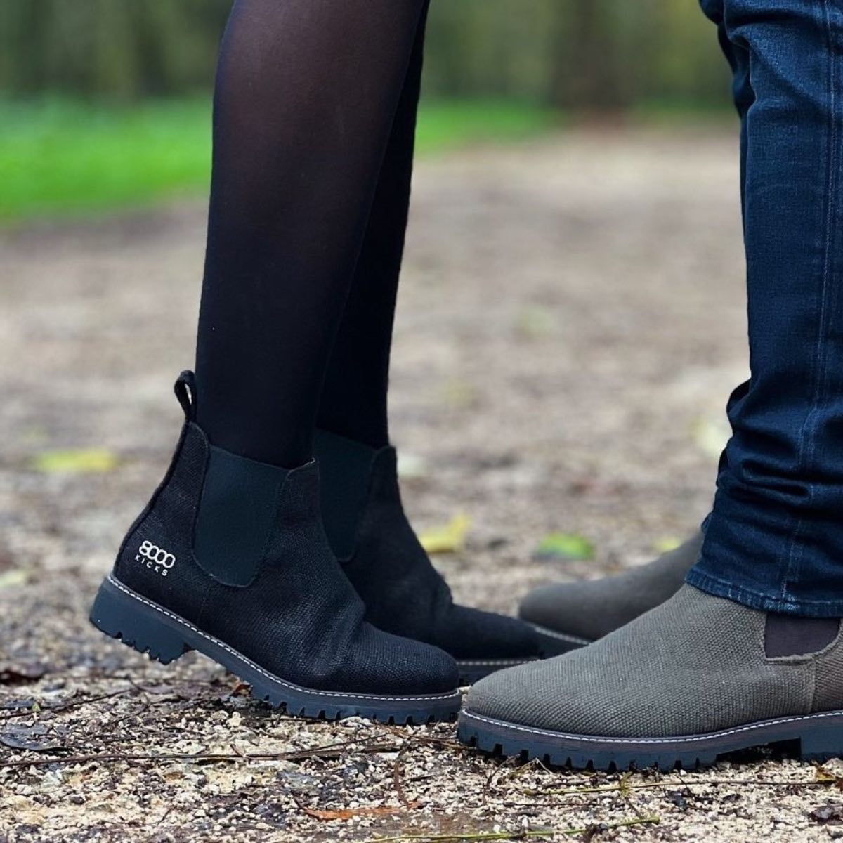 A man and a woman wearing vegan chelsea boots from 8000 kicks in black and grey.