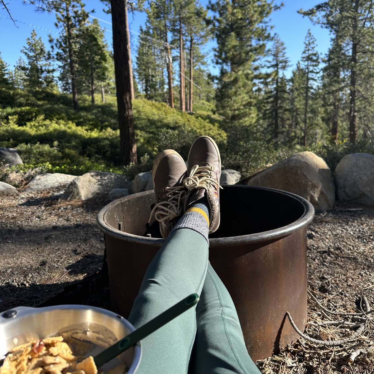 Woman wearing vegan hiking boots while camping in the woods in Lake Tahoe.