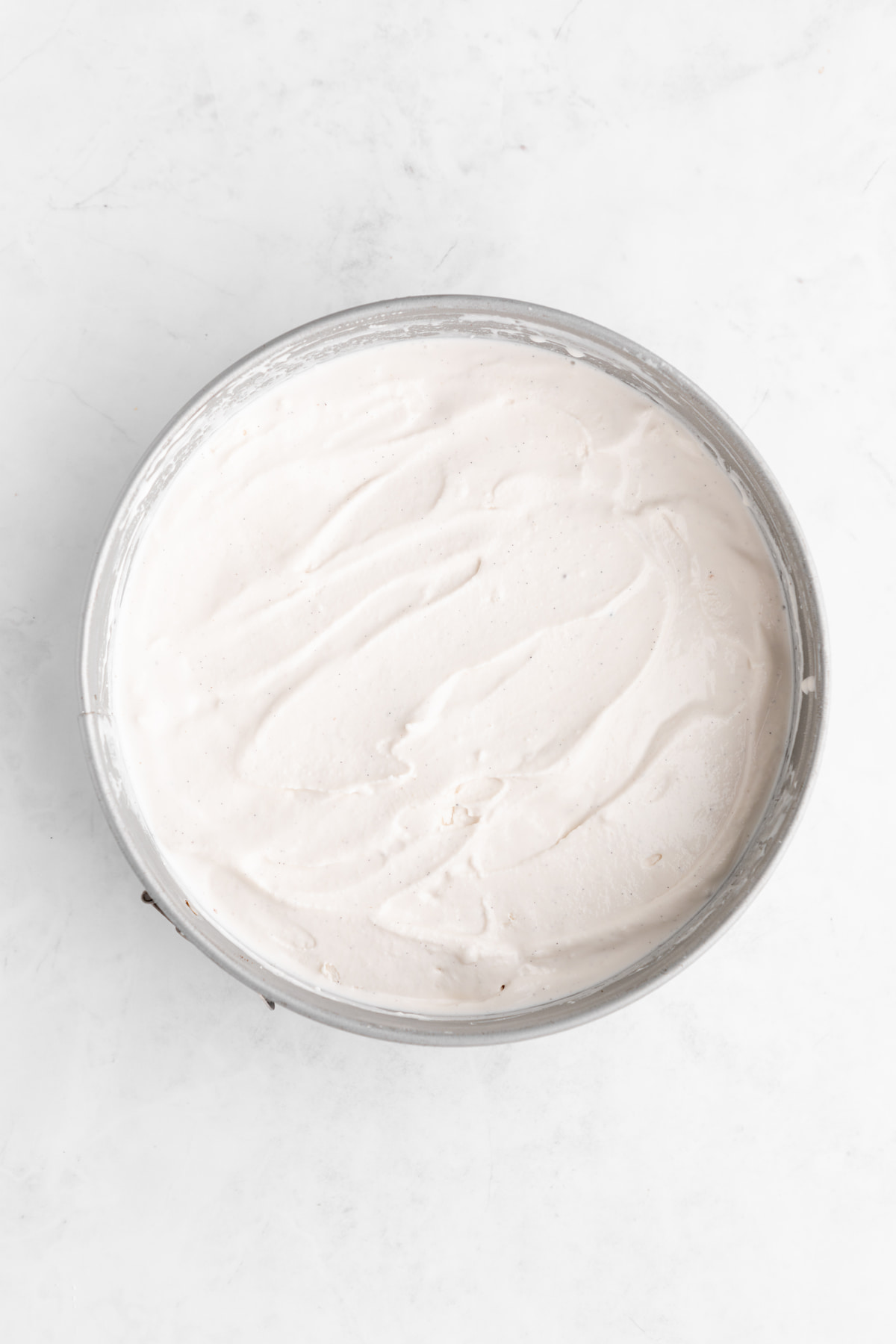 Vegan vanilla ice cream added to the prepared springform pan.