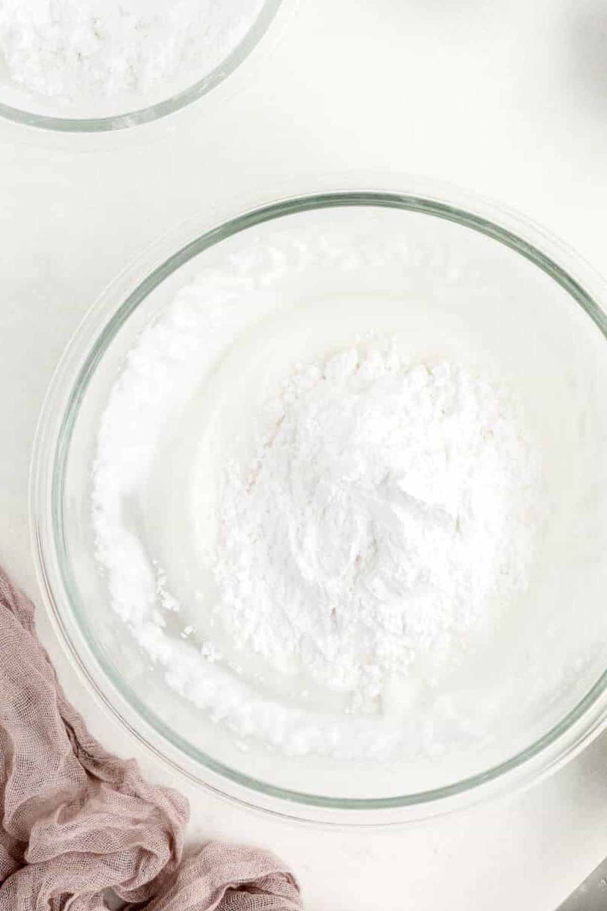 Powdered sugar in a bowl to make vegan icing.