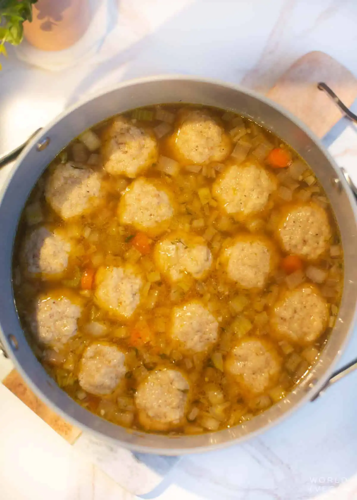 Matzo balls simmering the the soup pot.