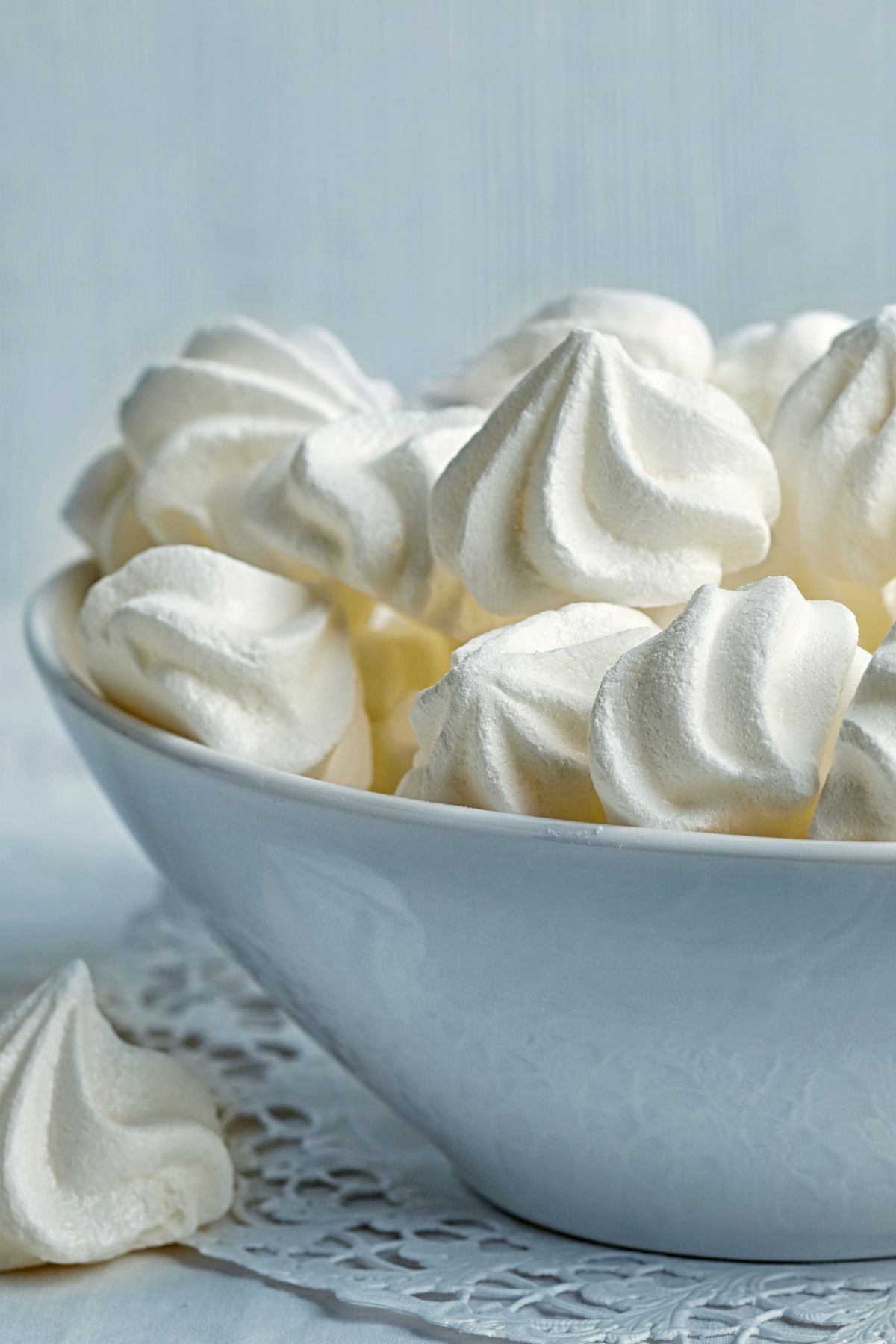 Bowl filled with vegan meringue cookies, highlighting their airy texture and elegant, glossy finish.
