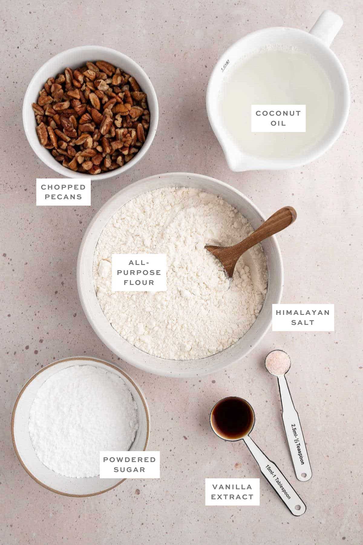 Key ingredients for vegan Mexican wedding cookies with labels.