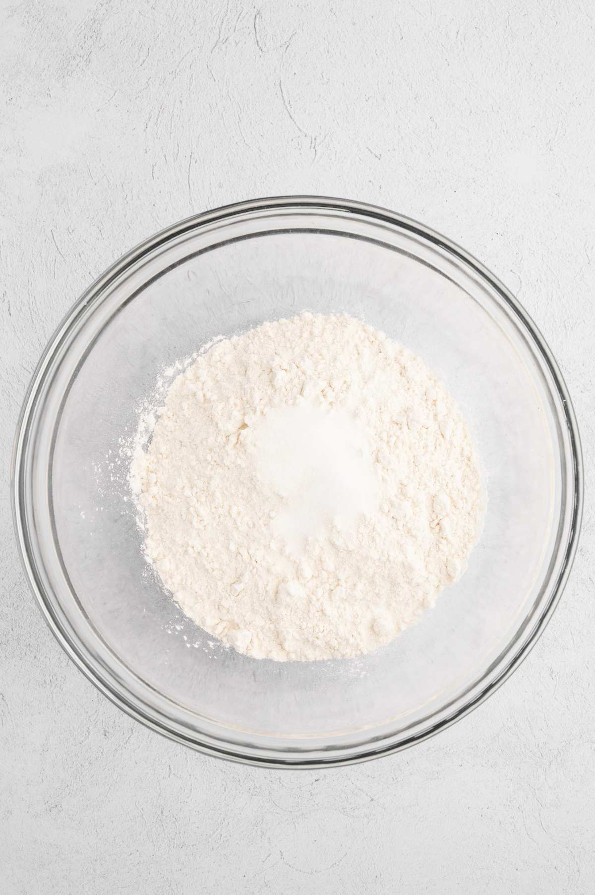 Dry ingredients for vegan pie crust in a mixing bowl.