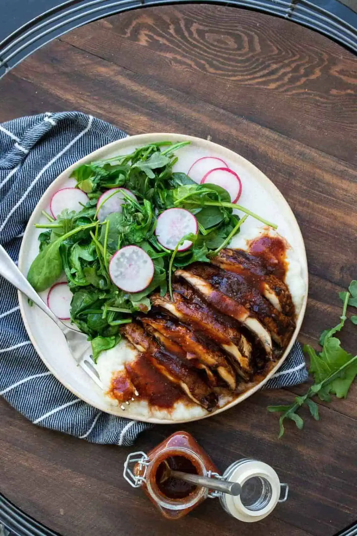 Sliced portobello mushroom steak on a plate with a salad.