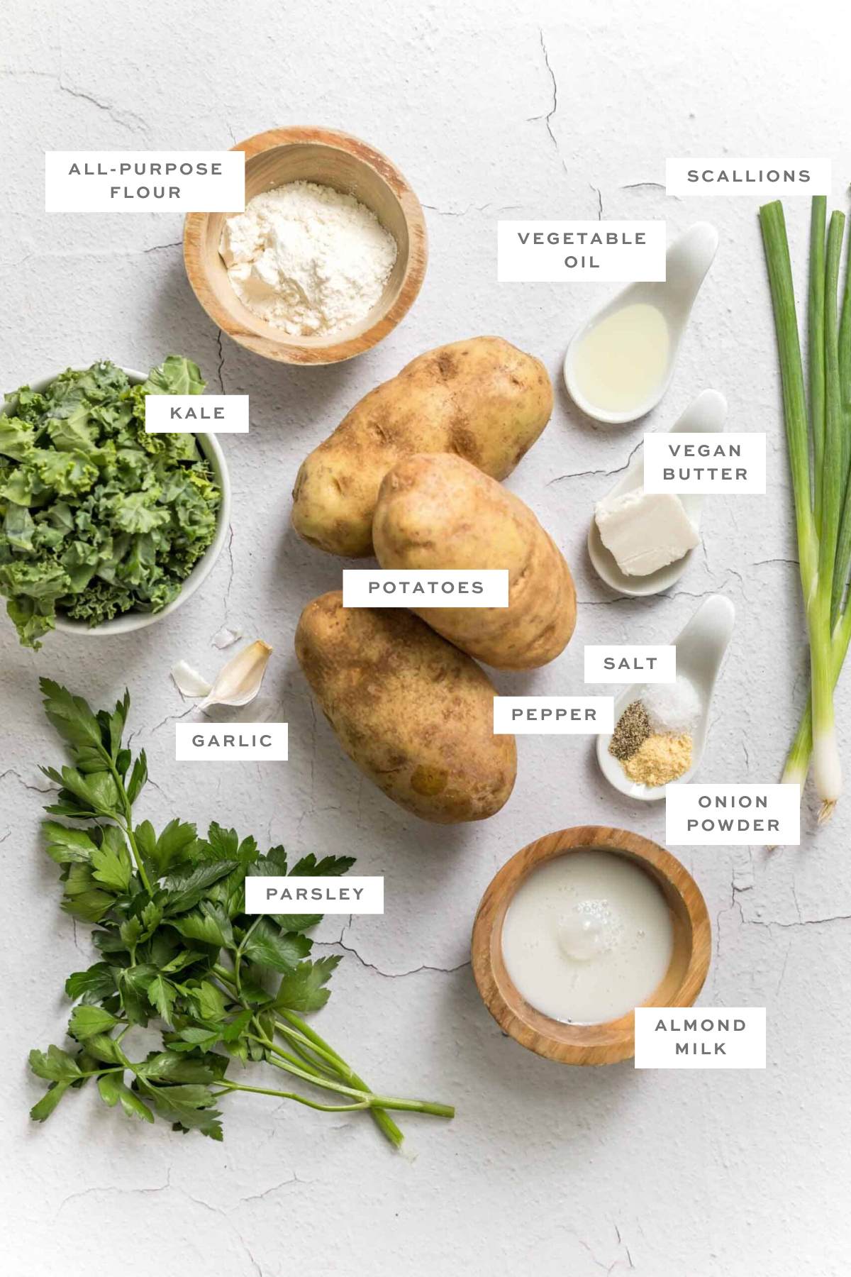 Gathered ingredient for vegan potato cakes with labels.