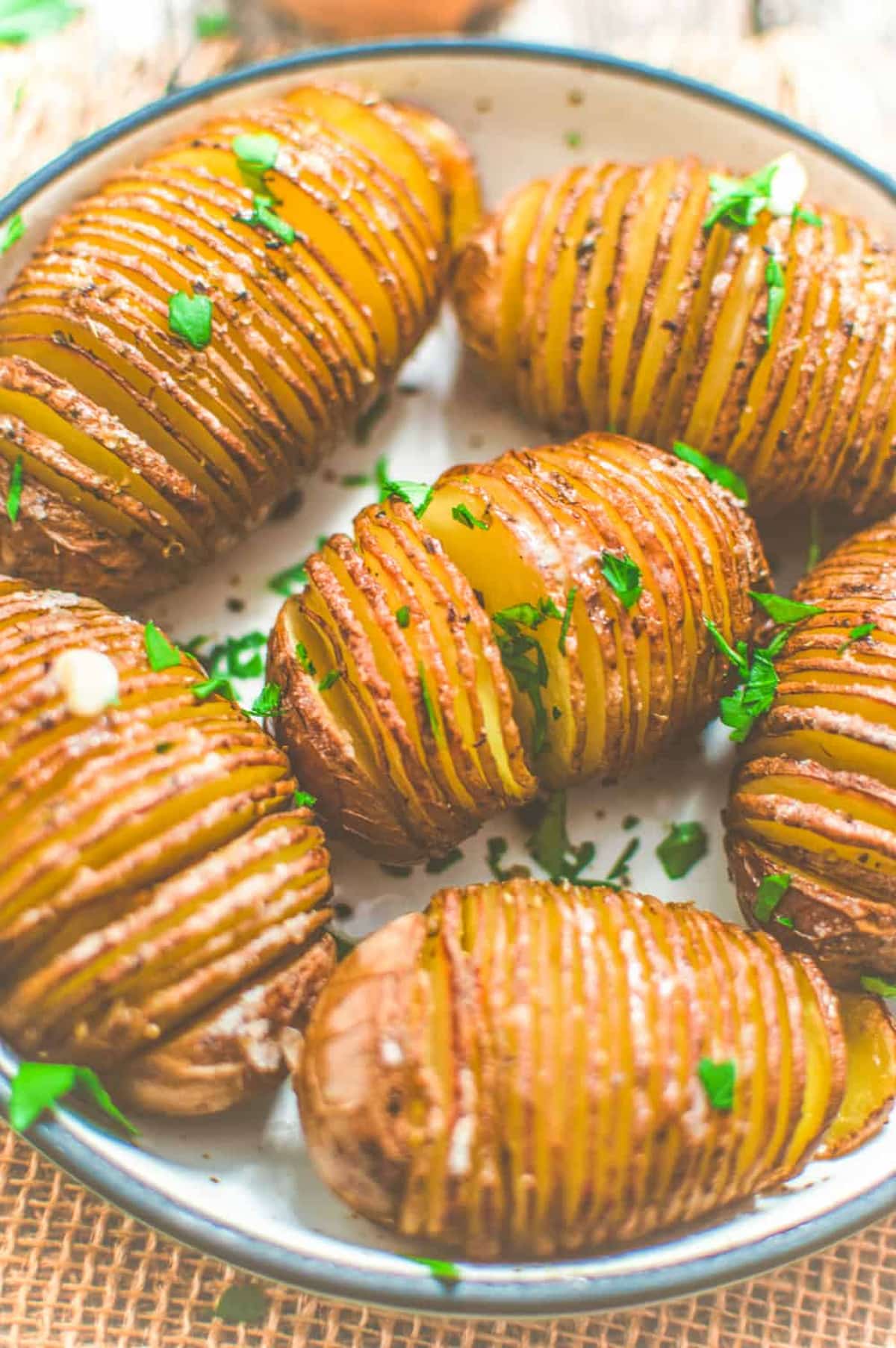 A plate of vegan Hasselback potatoes.