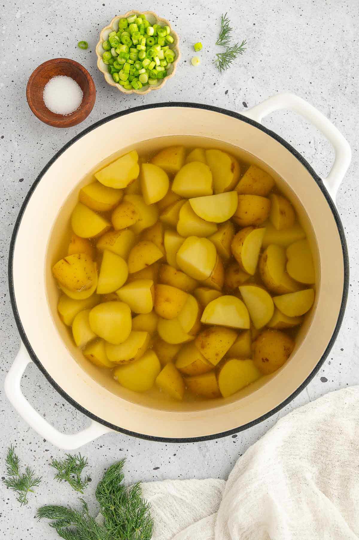 Cut potatoes in a bot with water.