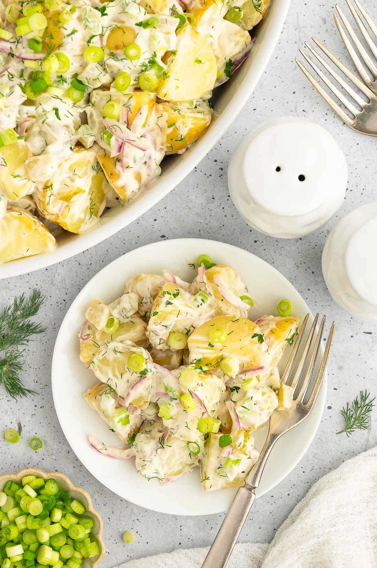 Vegan potato salad on a plate with fresh herbs and crunchy celery, perfect for summer BBQs.