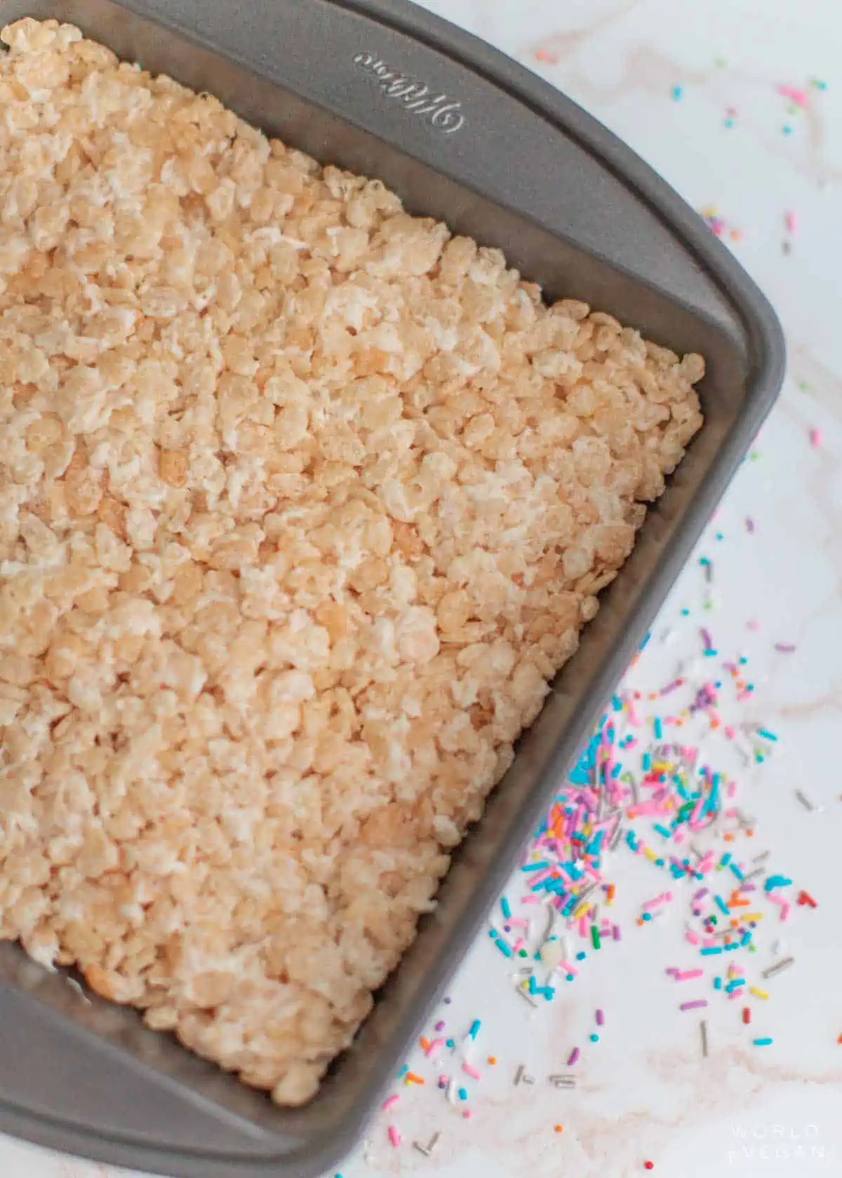 Pressed rice crispy treats mixture into the pan.