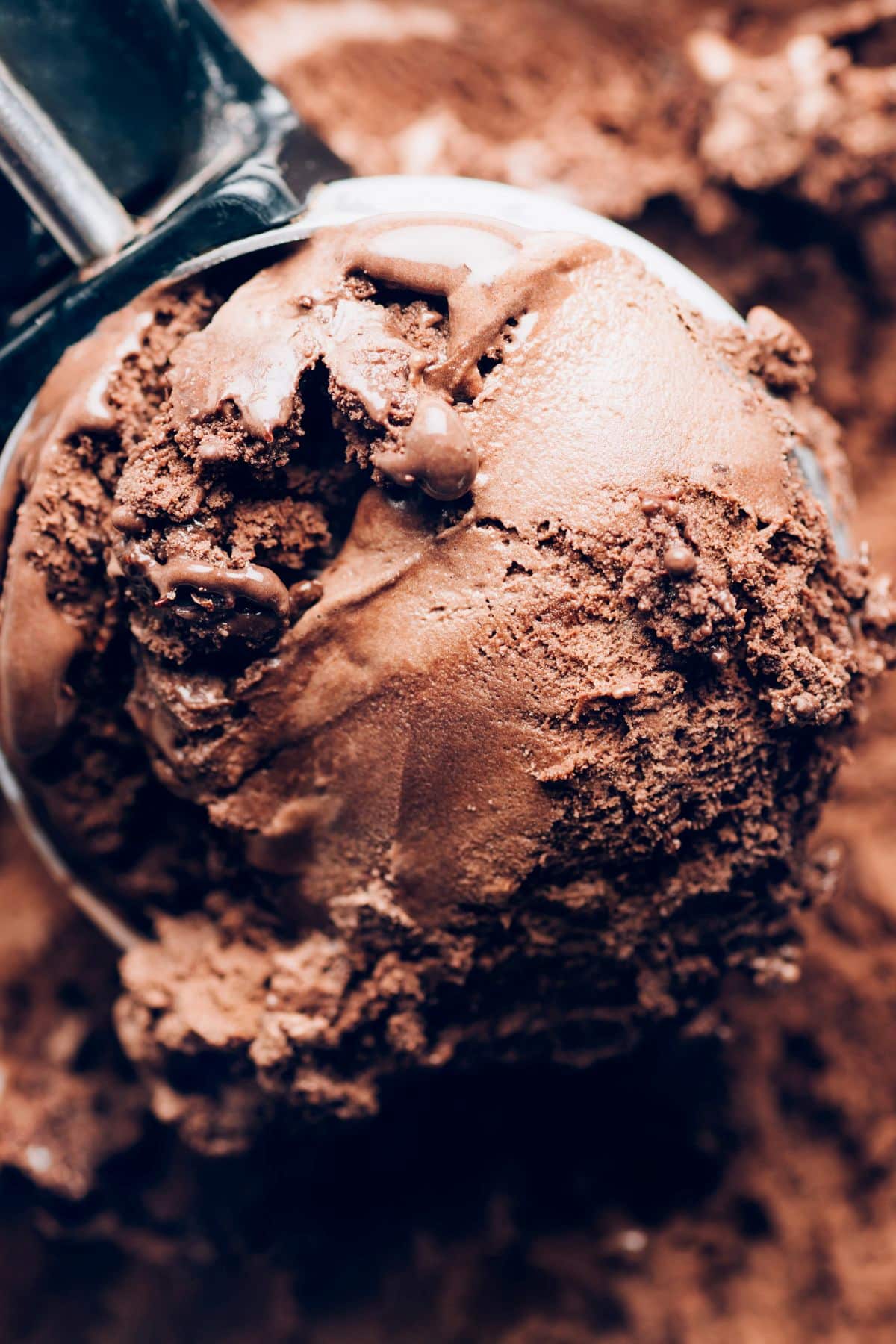 Scoop of vegan rocky road ice cream with marshmallows and almonds—rich, chocolatey, and nostalgic.