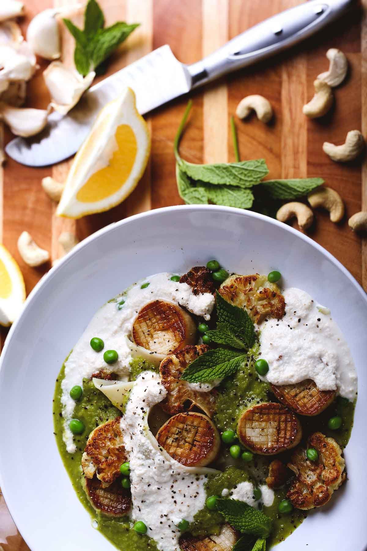Vegan scallops made from king oyster mushrooms with pea purée, roasted cauliflower, and pasta.