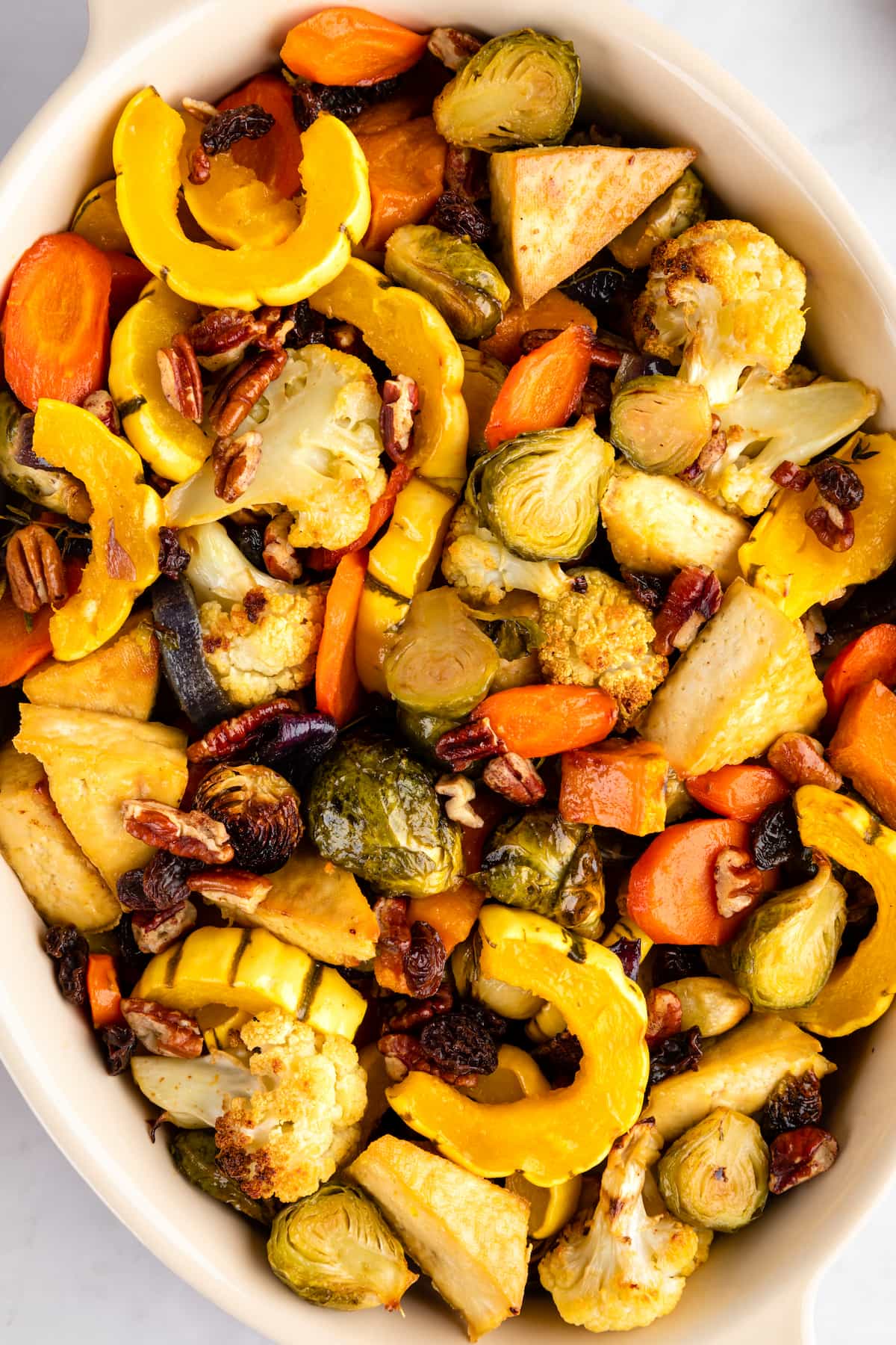 Vegan sheet pan dinner served in a baking dish with tofu and roasted autumn vegetables.