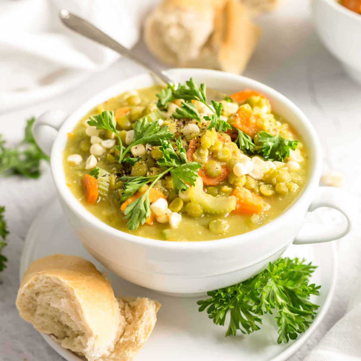 Vegan split pea soup served in a bowl and topped with fresh parsley.
