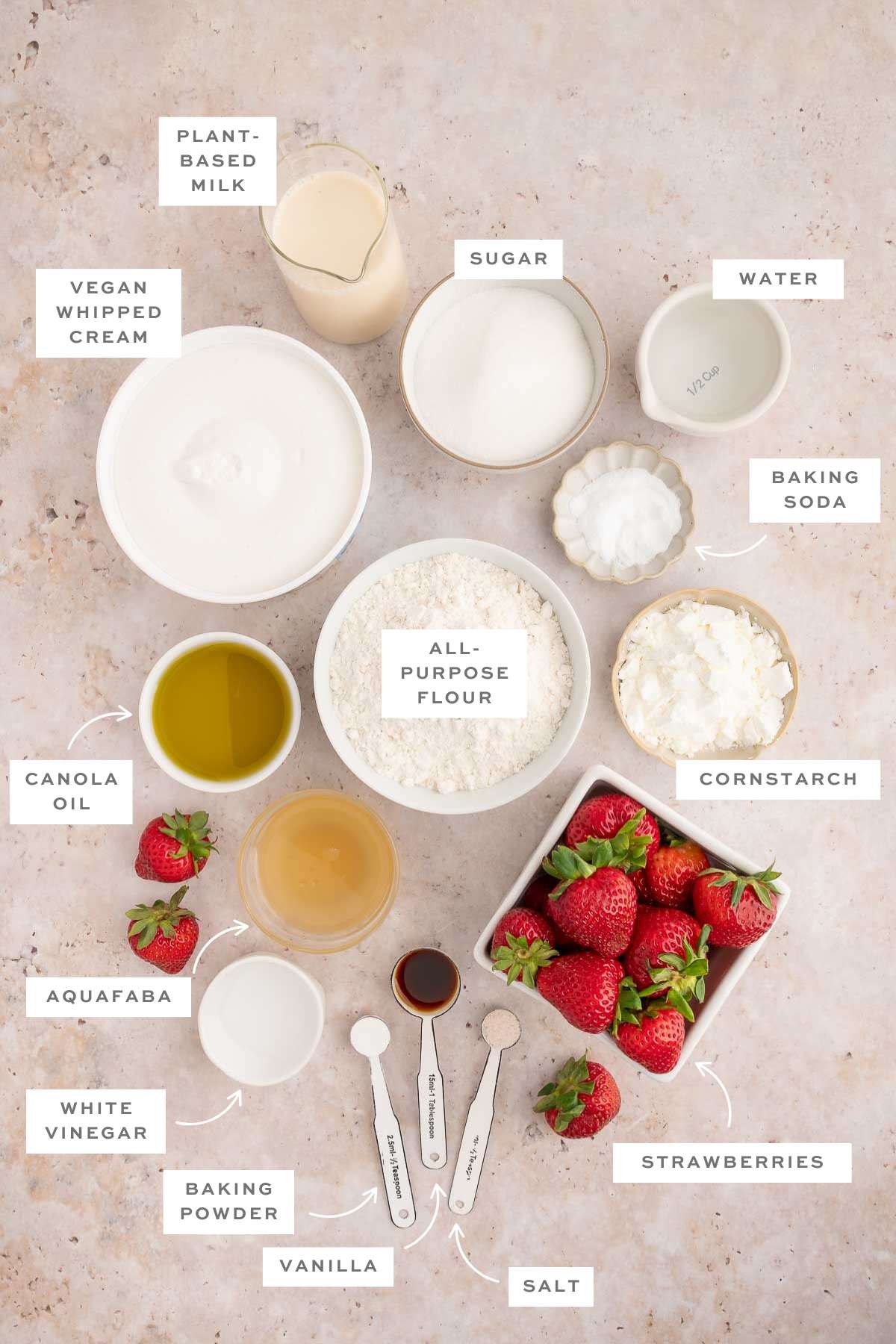 Gathered ingredients for vegan strawberry shortcake cake measured out into individual bowls with labels.