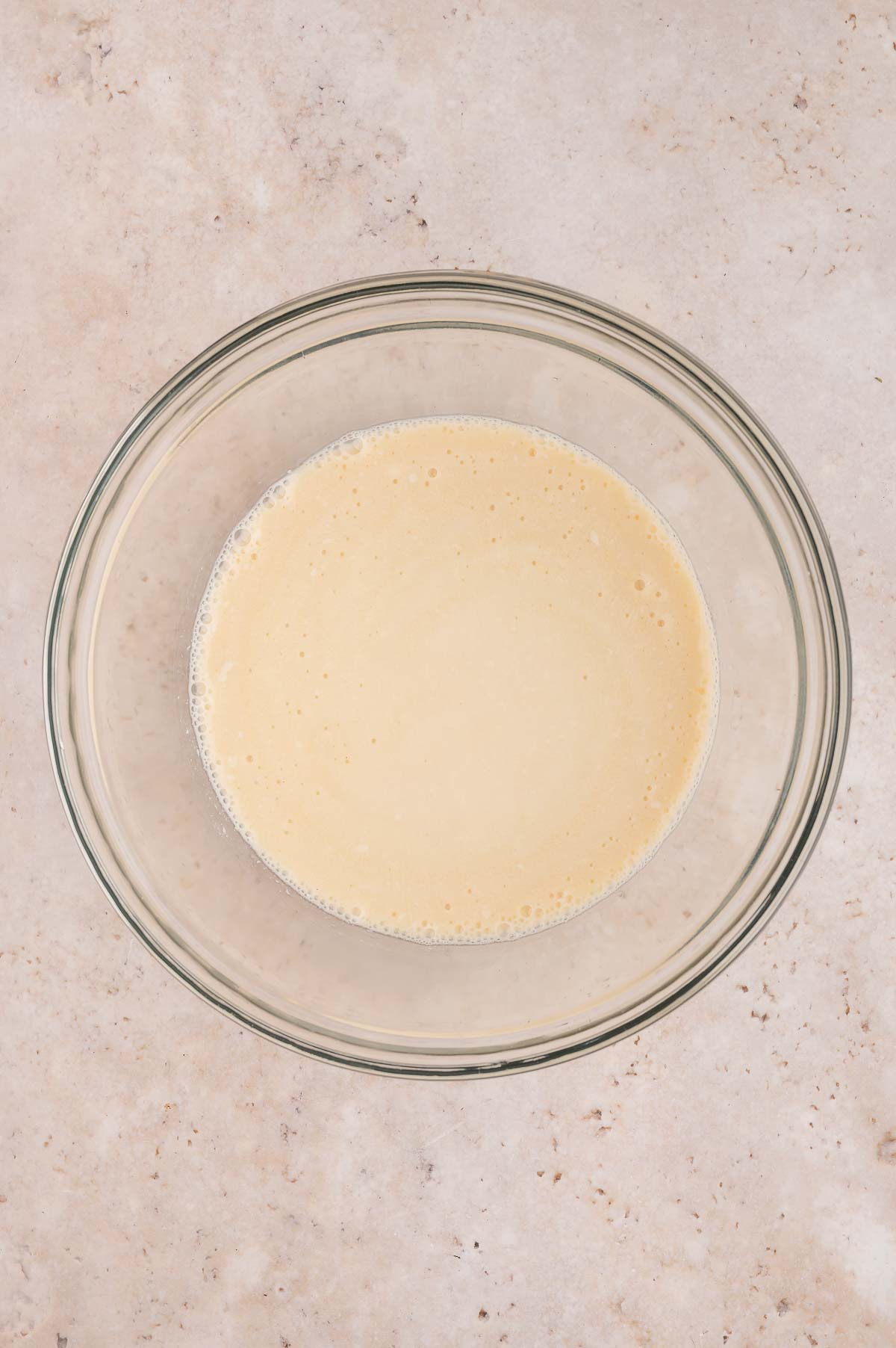Wet ingredients for the vegan strawberry shortcake mixed together in a glass bowl.