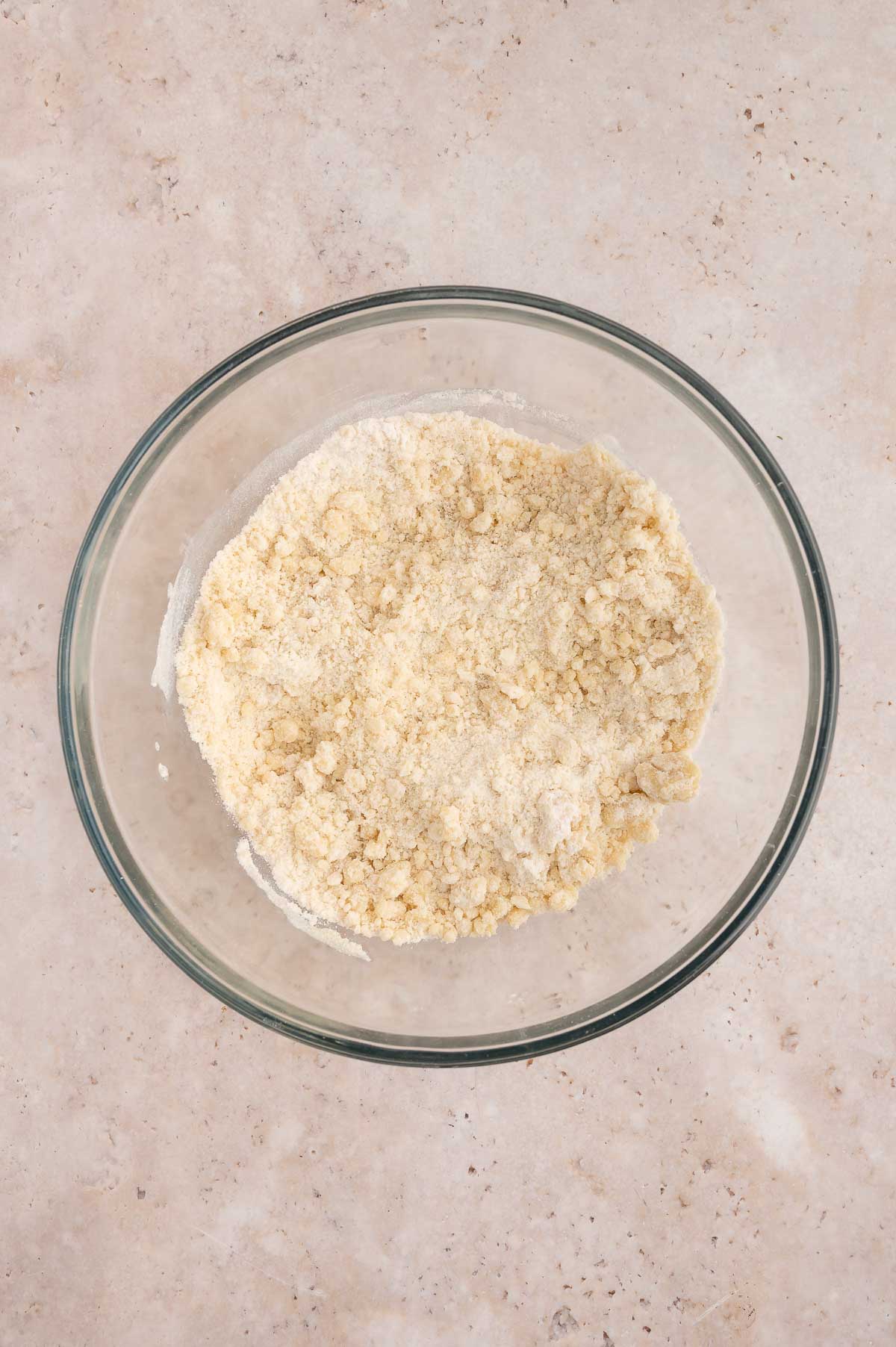 Dry ingredients mixed with oil in a large glass mixing bowl.