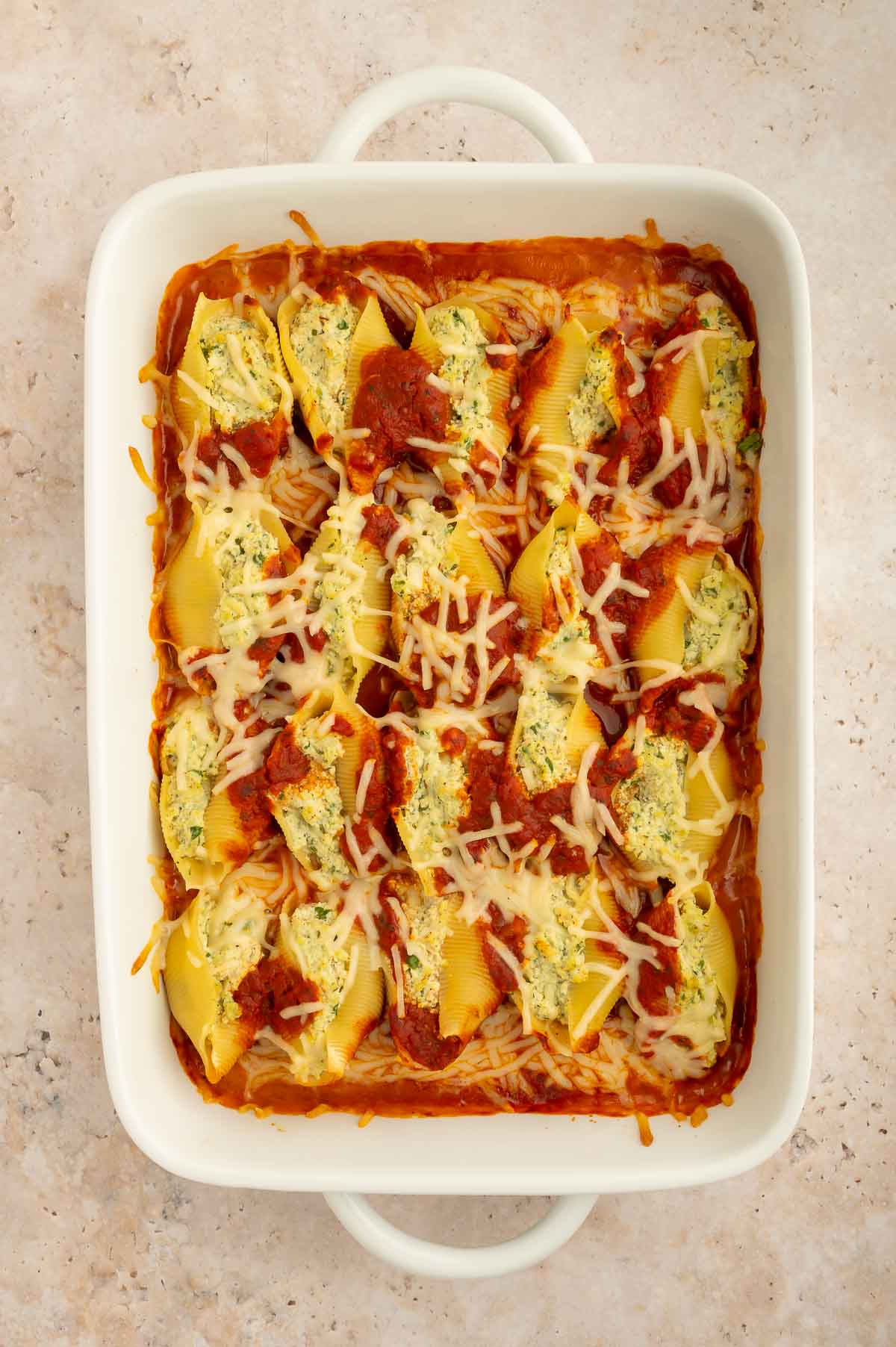 Ricotta-stuffed pasta with vegan shredded cheese on top.