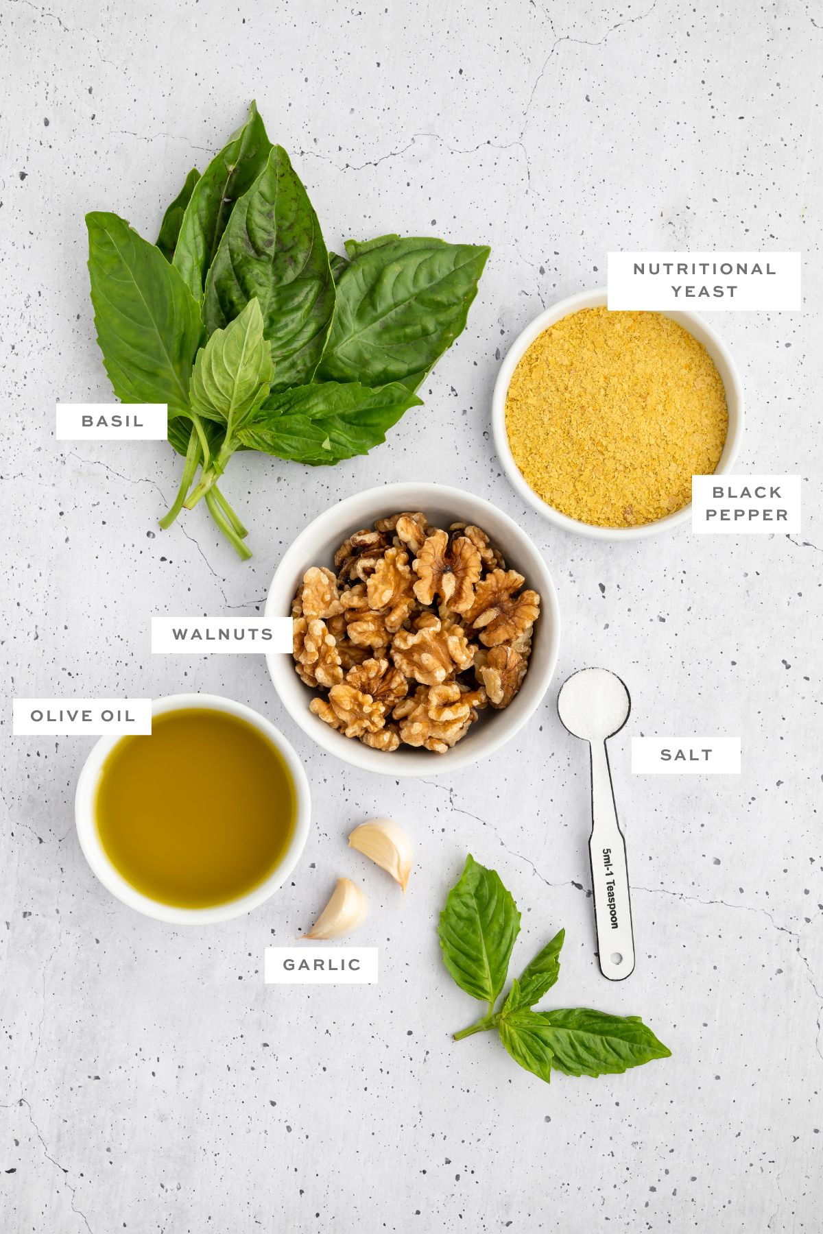 Gathered ingredients for this walnut pesto recipe measured out and labeled.